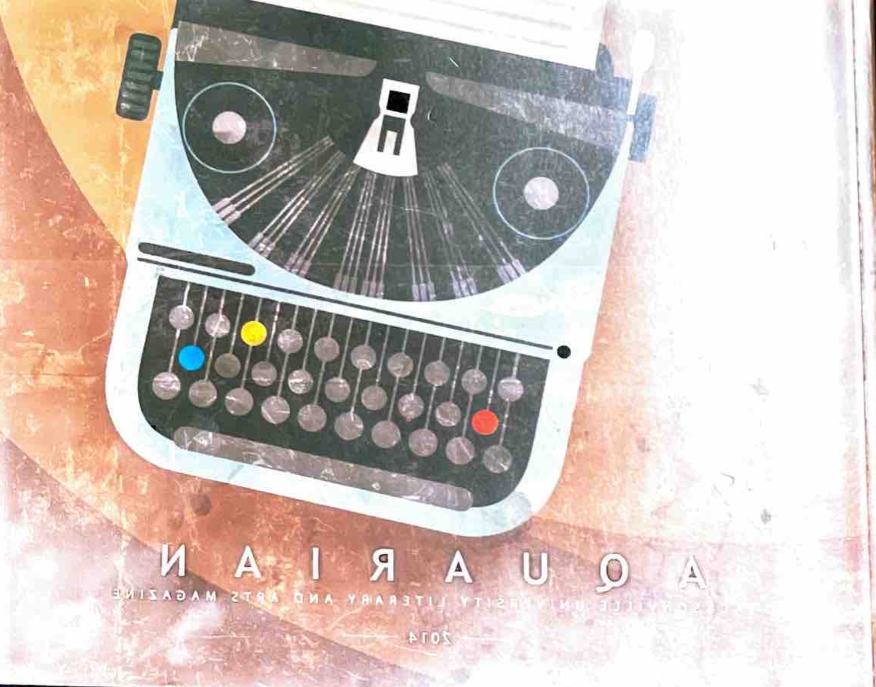 2014 Cover with a grey and blue typewriter, a brown background,and the Title Aquarian